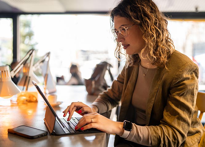 Woman using laptop in community workspace