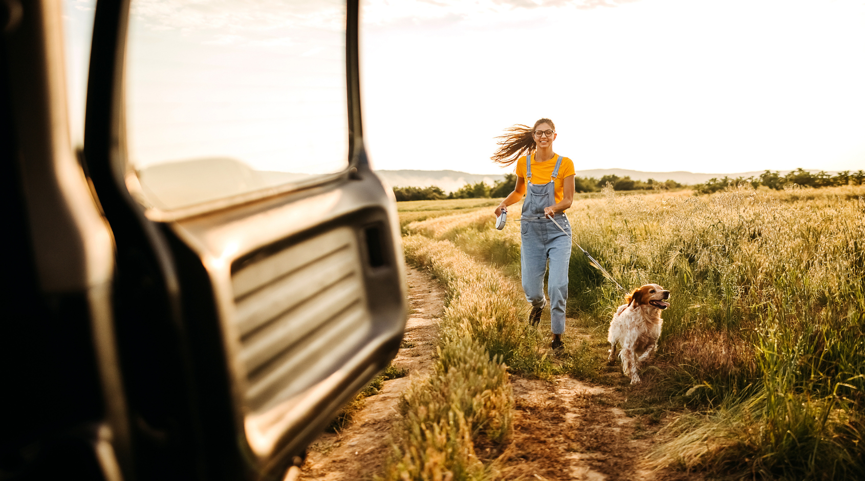 woman running with dog in field