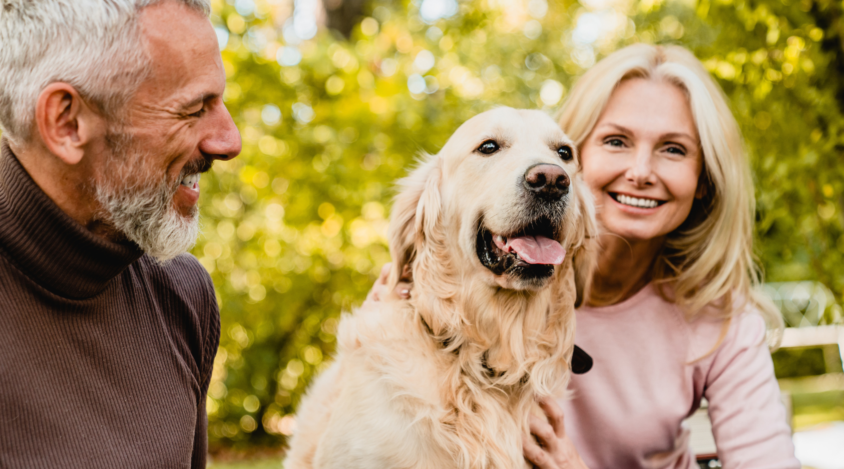 man and woman with golden retriever