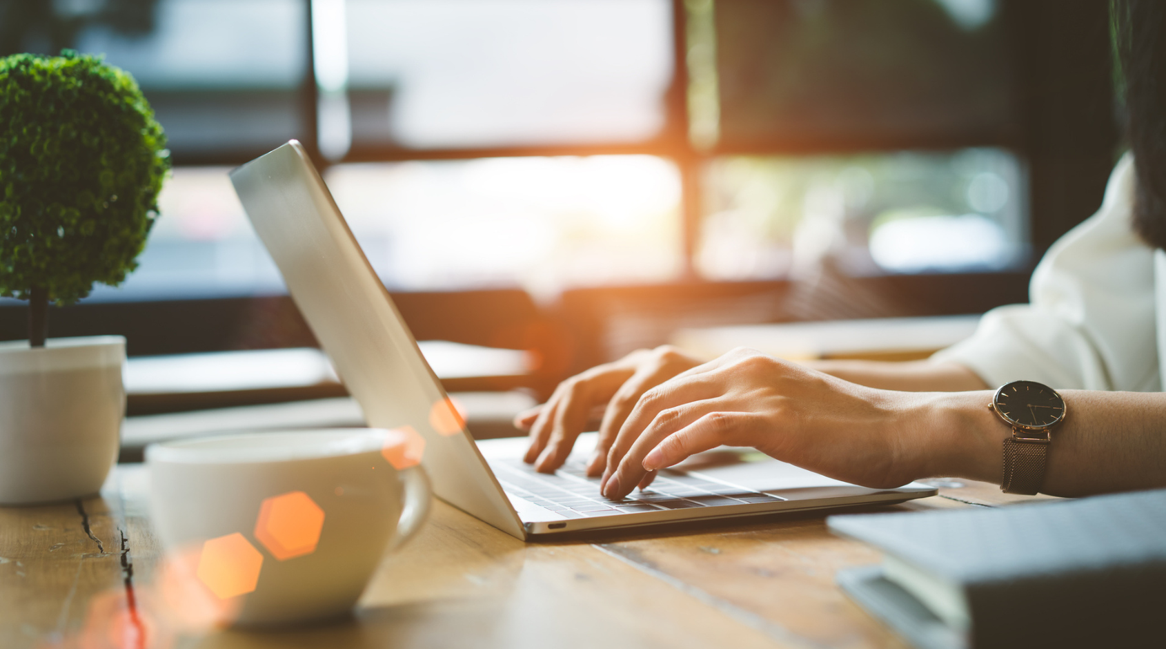 hands typing on laptop