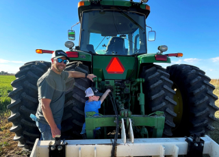 father and son working on tractor