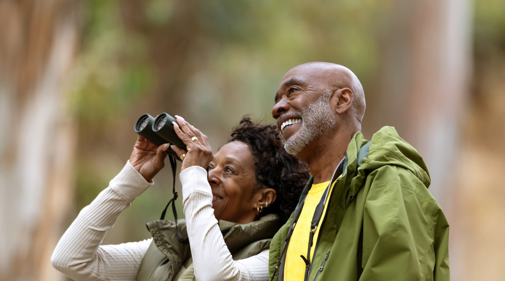 husband and wife using binoculars