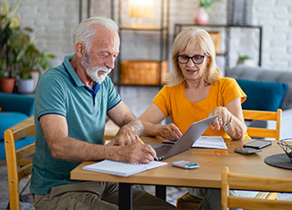 Senior couple going over finances in kitchen