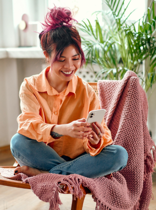 woman sitting outside with phone