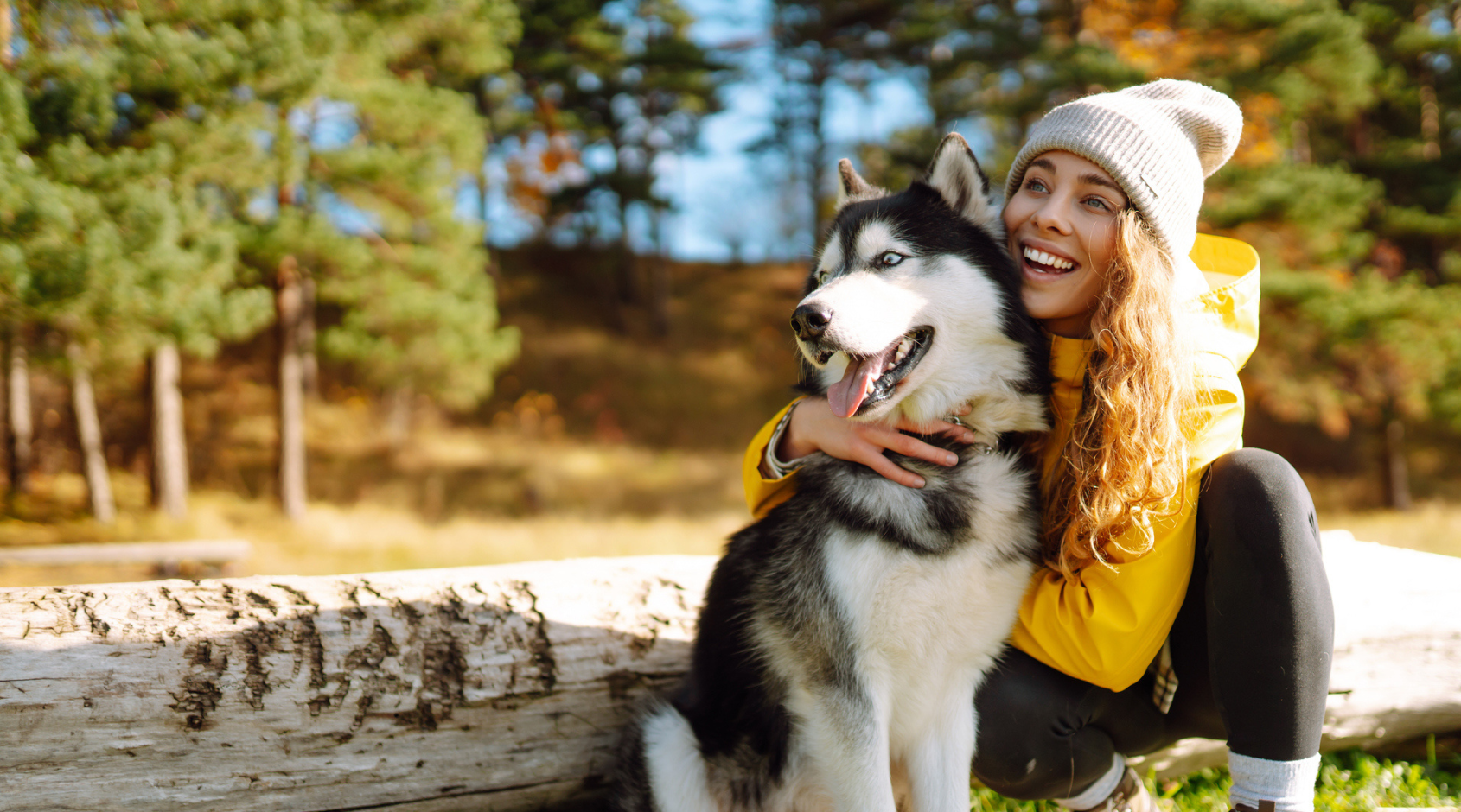 woman hugging a husky