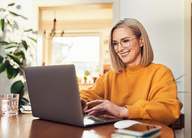 Woman using laptop in home office