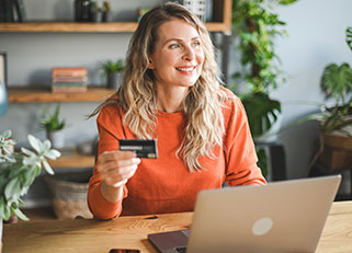 Woman using credit card for online shopping