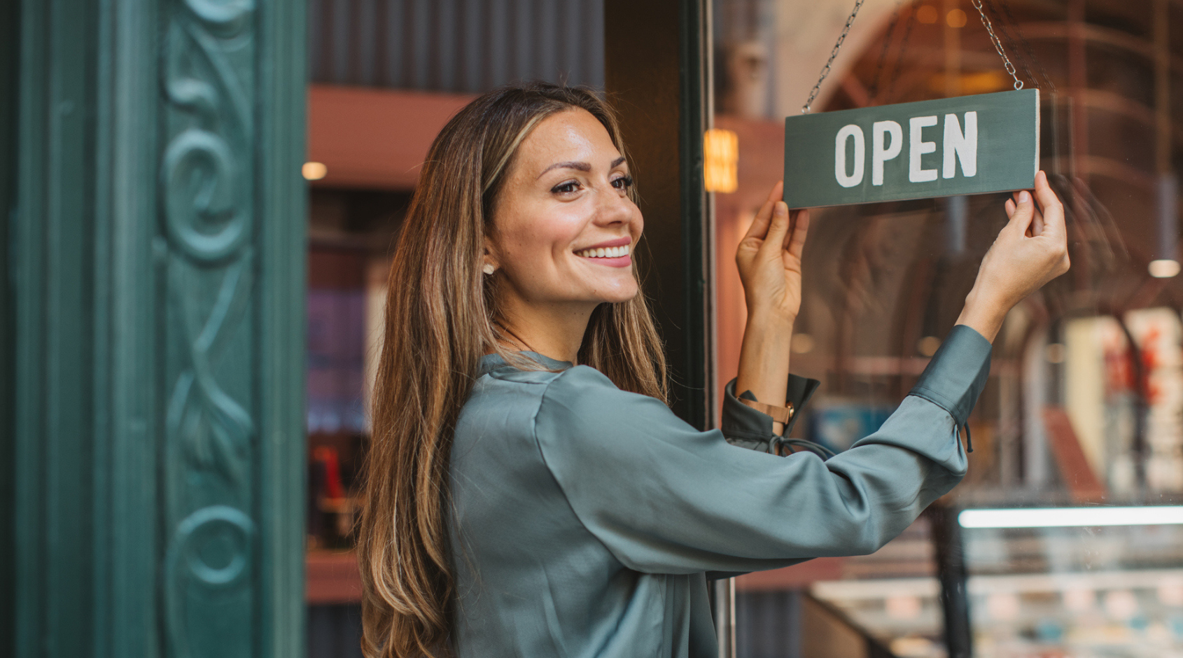 shop owner with open sign