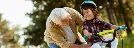 grandpa teaching grandson to ride bike