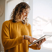 Woman using tablet in living room